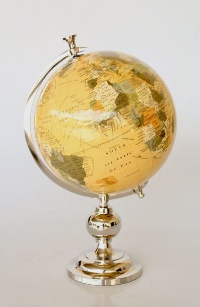 antique world globe on silver stand