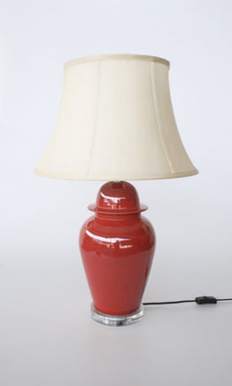 Red lamp with perspex base and cream shade